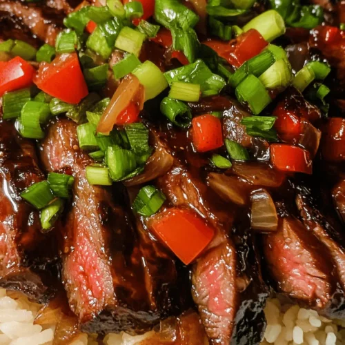 Sizzling Pepper Steak with Onions is a vibrant and flavorful dish that brings the best of Asian cuisine right to your dinner table. This delectable recipe showcases tender flank steak paired with crisp bell peppers and aromatic garlic and ginger. The result is not only a feast for the taste buds but also a colorful addition to your meal plan. Perfect for weeknight dinners or gatherings, this dish offers a delightful combination of textures and flavors that will leave everyone asking for seconds.